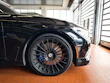 Sporty black alloy wheels shining under showroom lights