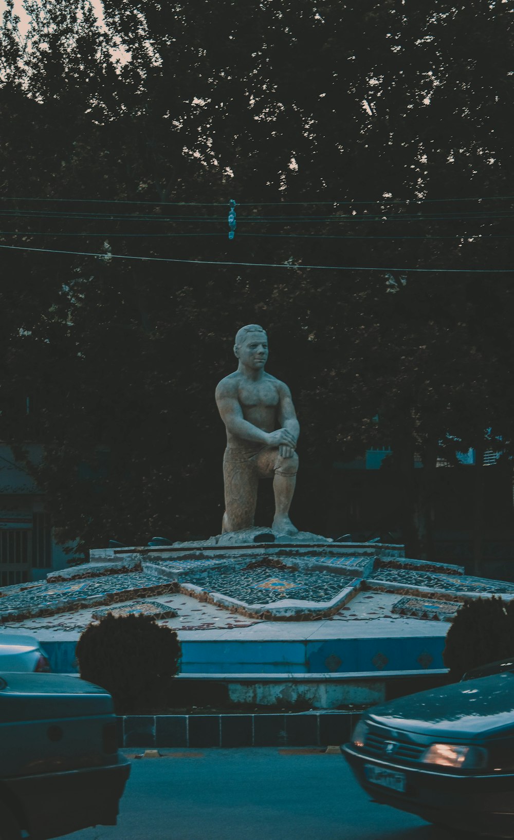 a statue of a man standing on top of a building