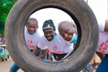 a group of men standing next to each other in front of a tire