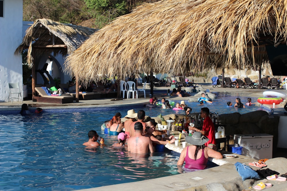 a group of people sitting around a pool