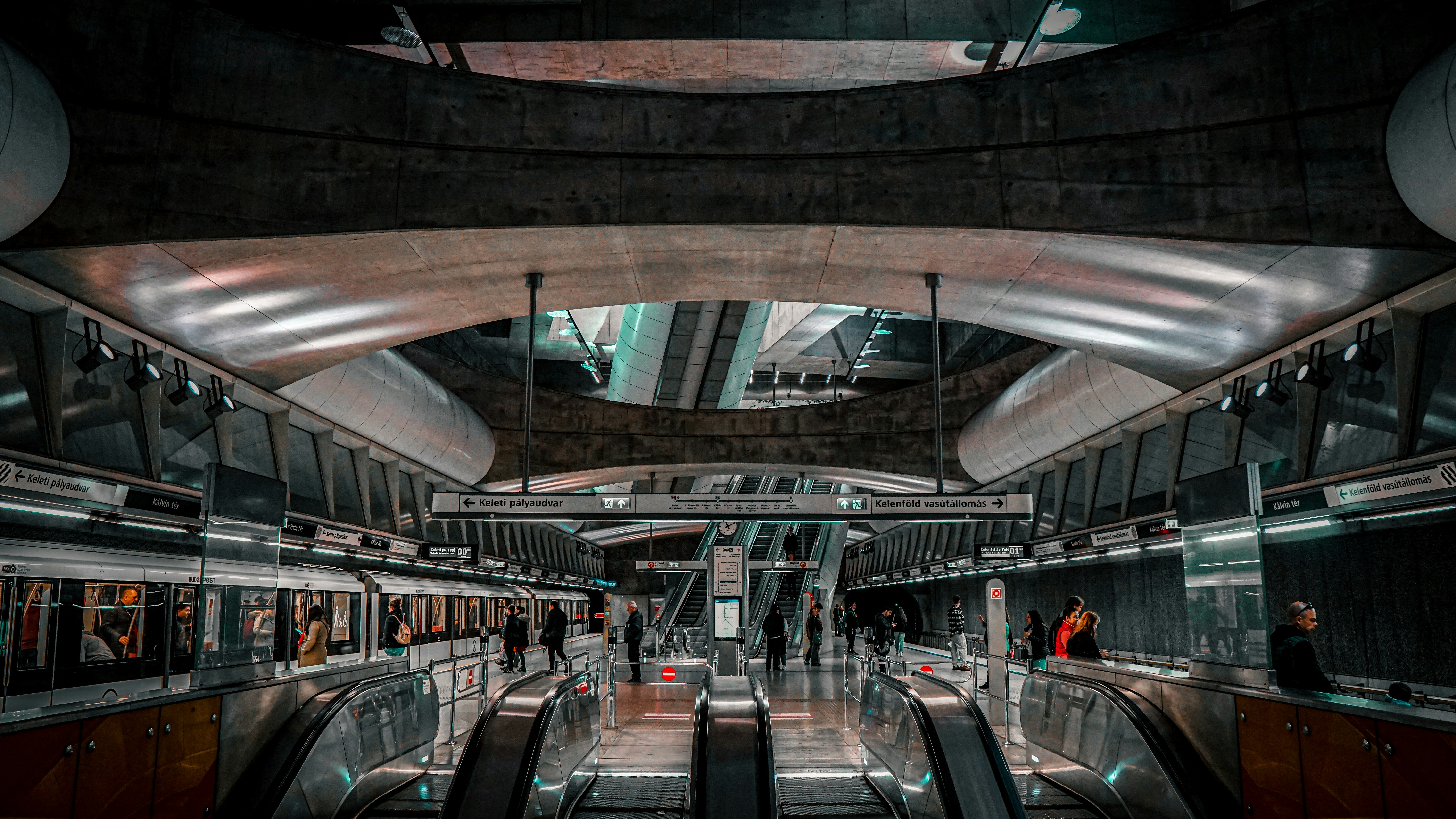 an escalator in a subway station with people on the escalators