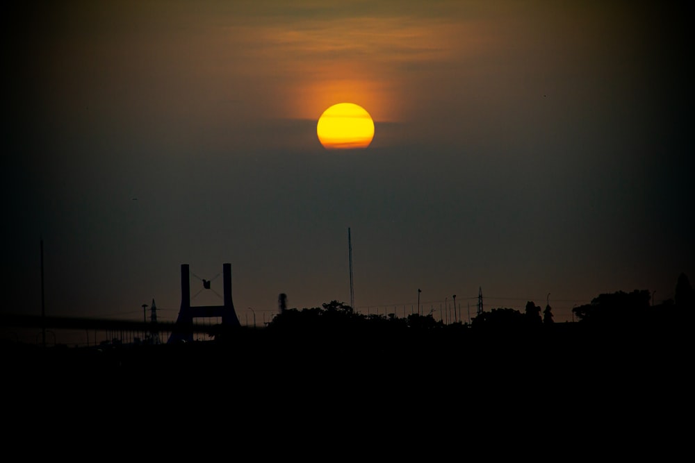 the sun is setting over the horizon of a city