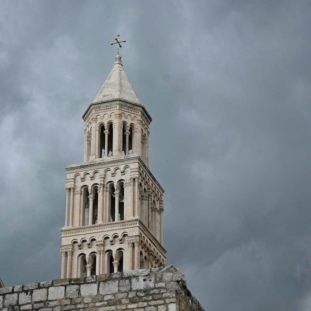 a tall tower with a cross on top of it