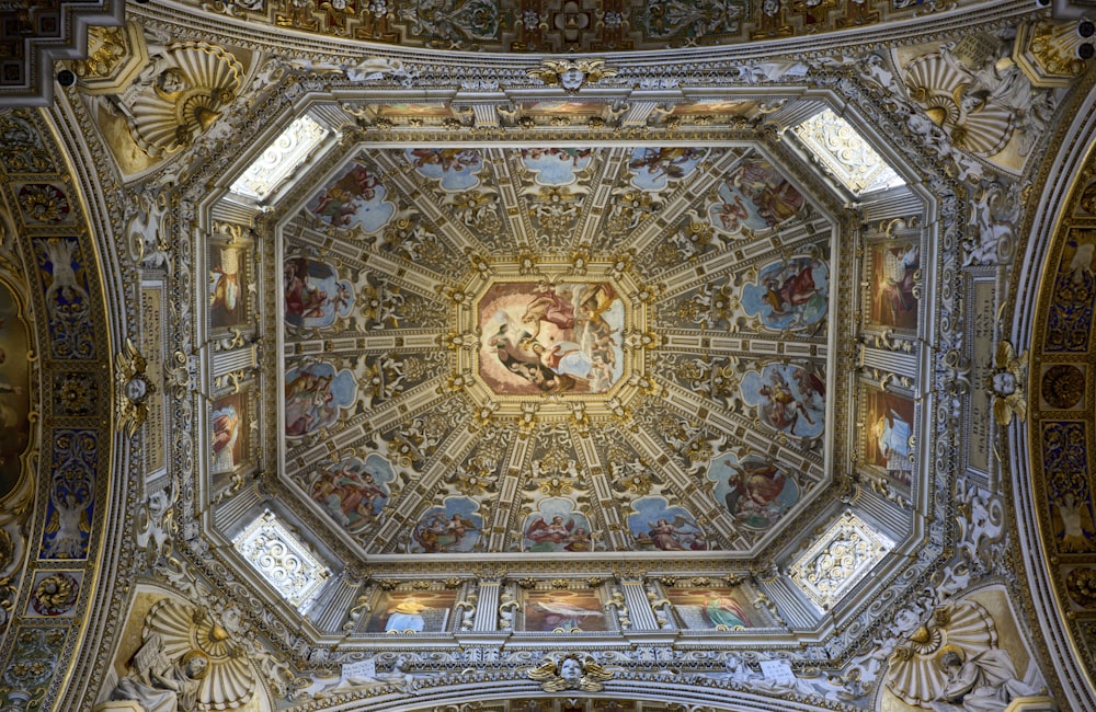 the ceiling of a building with a painting on it