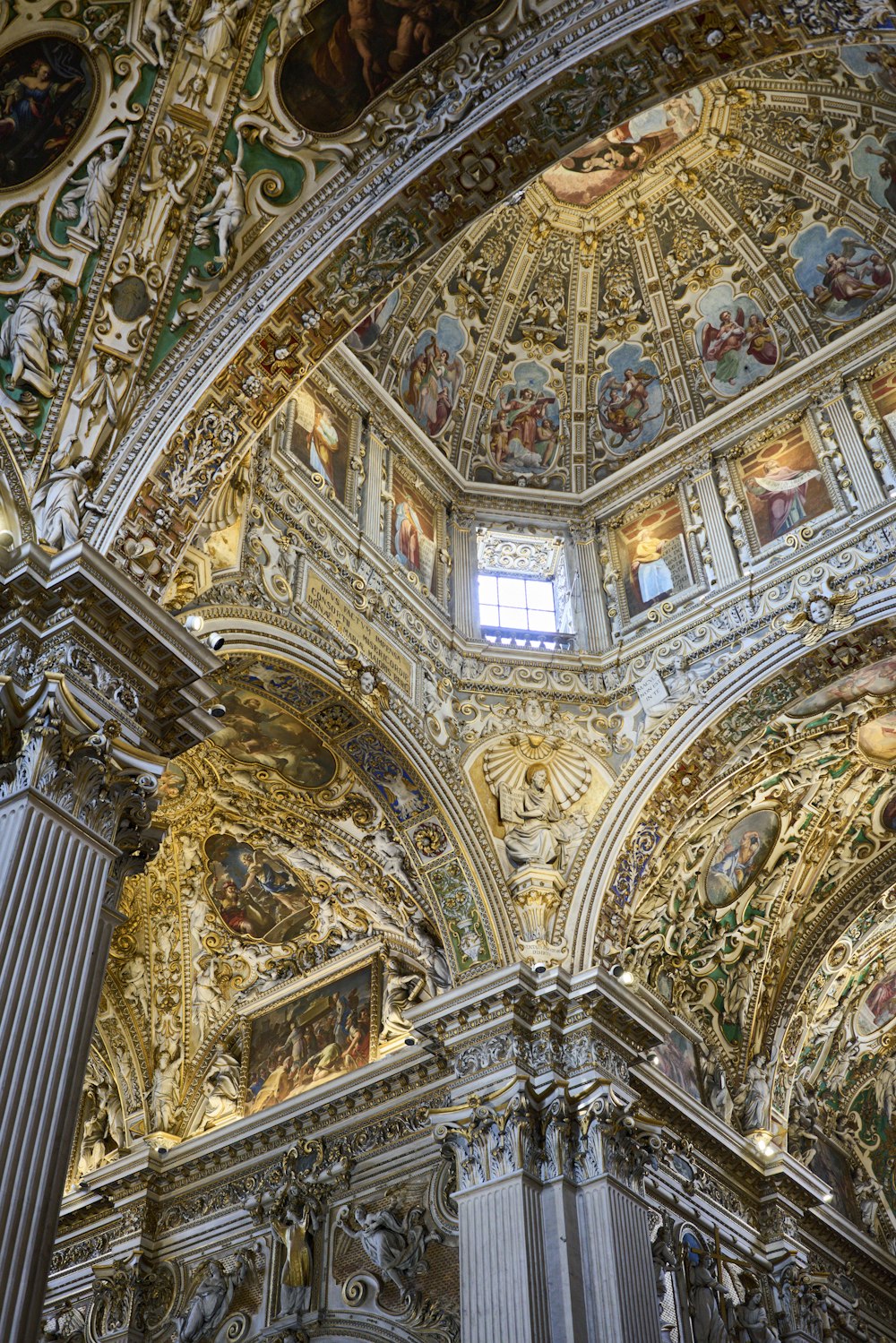 the ceiling of a church with paintings on it