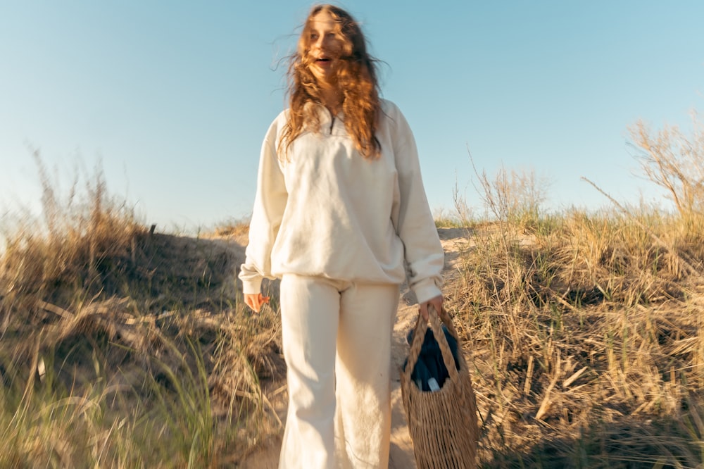 a woman in a white outfit holding a basket