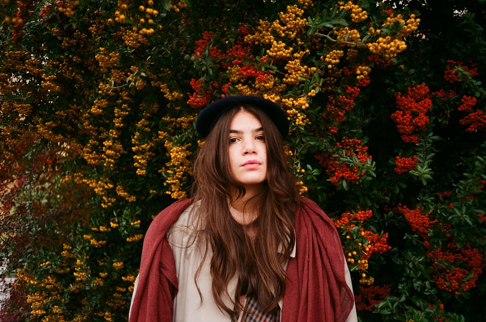 a woman with long hair wearing a hat and scarf