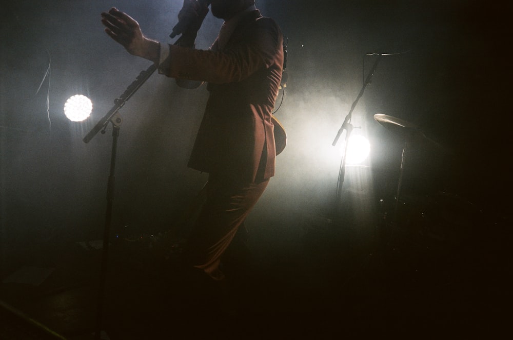 a man standing on a stage holding a microphone