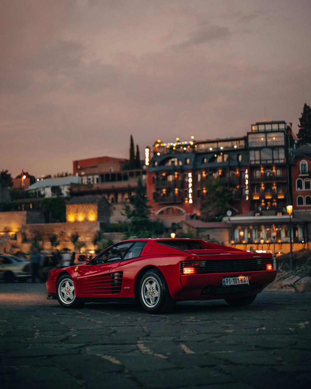 a red sports car parked in a parking lot