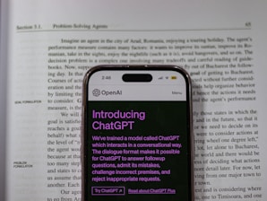 a cell phone sitting on top of an open book