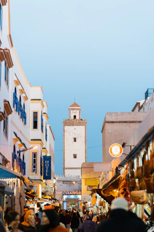 A bustling street market in Marrakech alive with vibrant colors and lively faces.