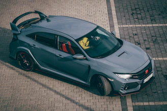 a grey sports car parked in a parking lot
