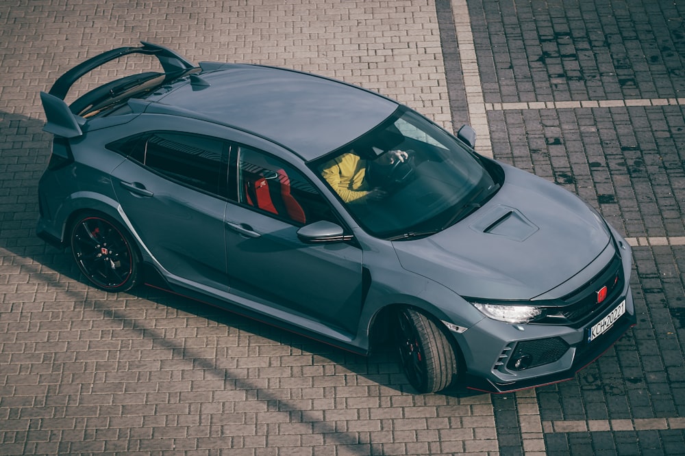 a grey sports car parked in a parking lot