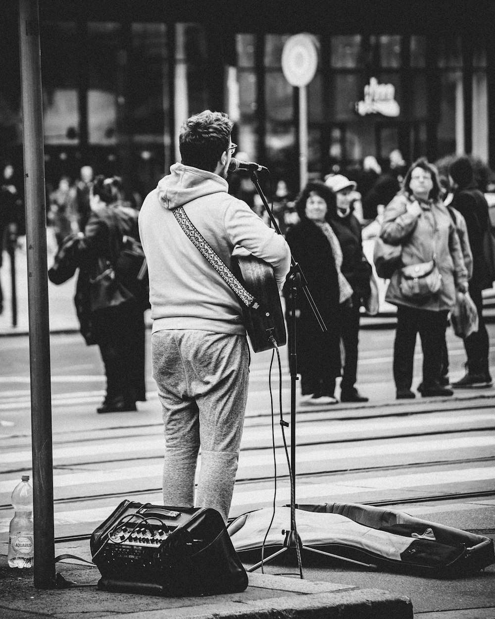 a man standing on a street corner with a microphone