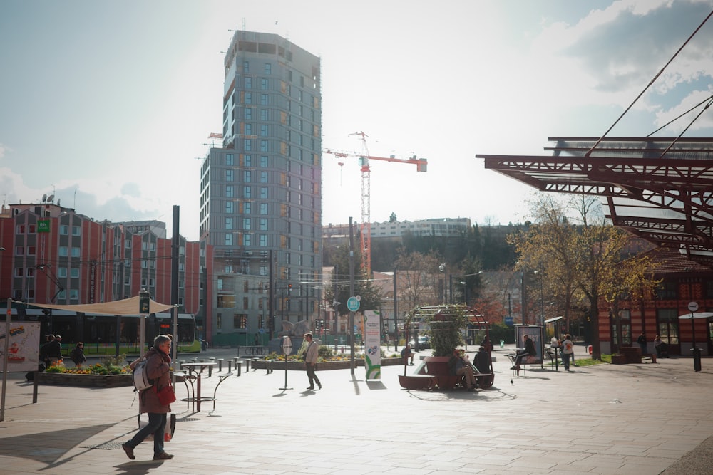 a group of people walking around a city square