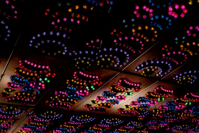 A cluster of colorful vector-inspired ceiling lights creating a vibrant atmosphere.