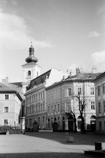 A striking black and white photo of an old city street at dawn, with soft light casting long shadows.