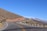 A scenic mountain road winding through the Pyrenees under a clear blue sky.
