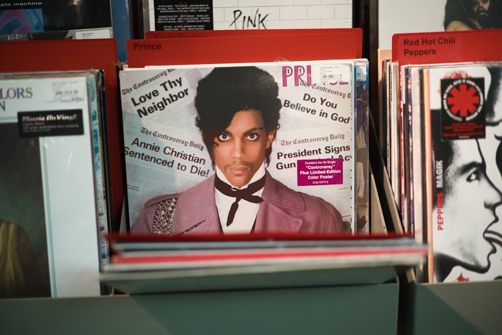 a stack of records with a magazine on top of it