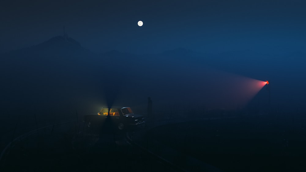 a foggy night with a full moon in the distance