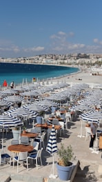 a bunch of tables and chairs on a beach