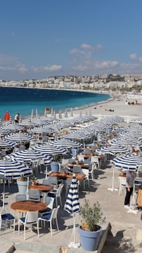 a bunch of tables and chairs on a beach