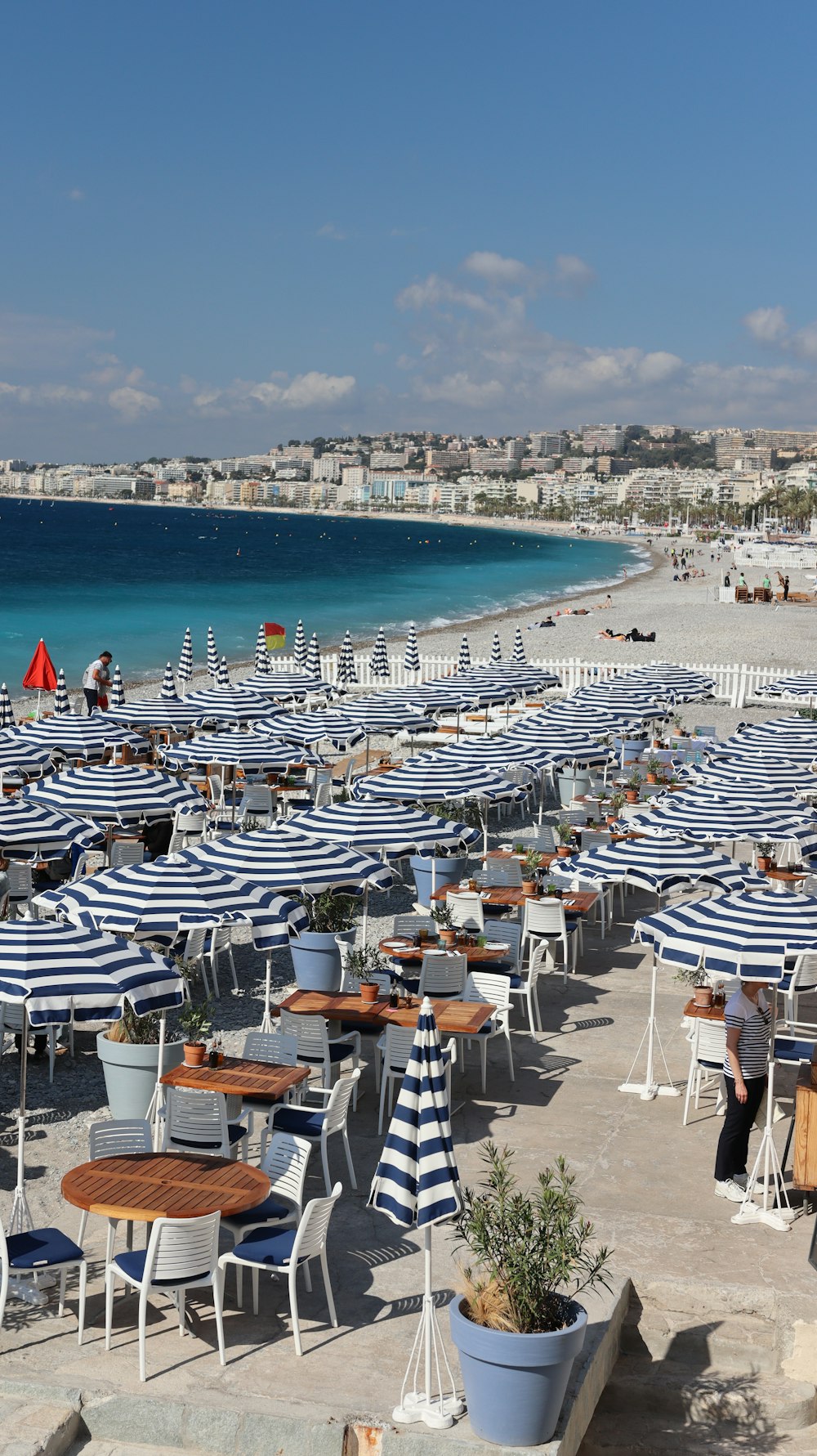 a bunch of tables and chairs on a beach
