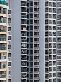 Close-up of a luxurious apartment balcony overlooking a vibrant urban neighborhood.
