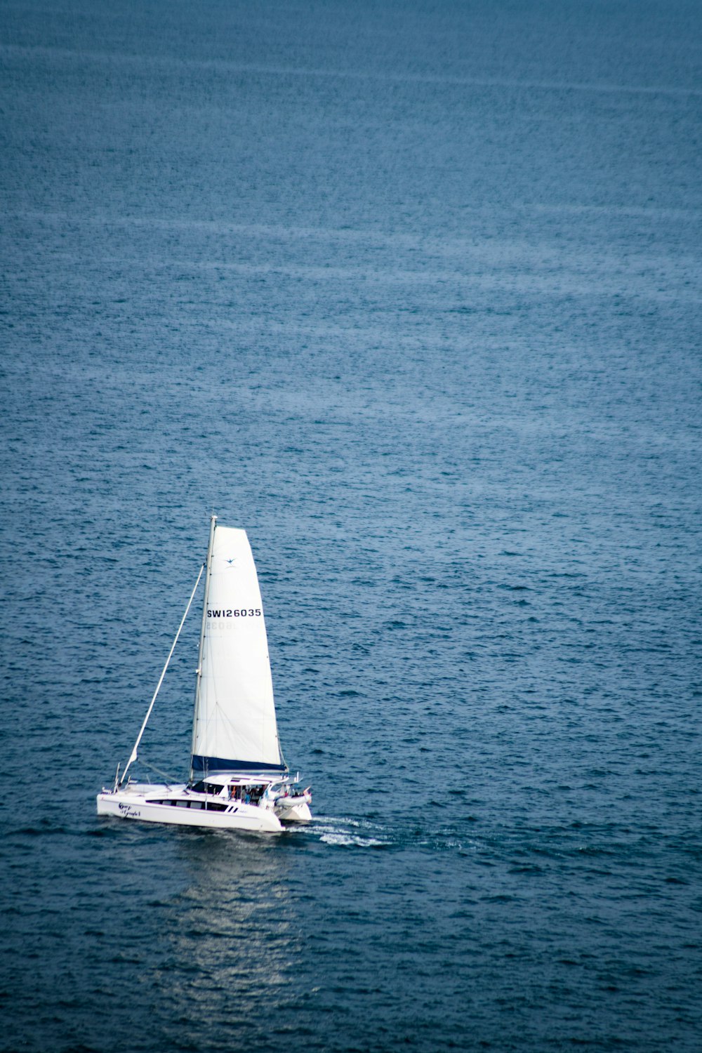 a sailboat in the middle of a body of water