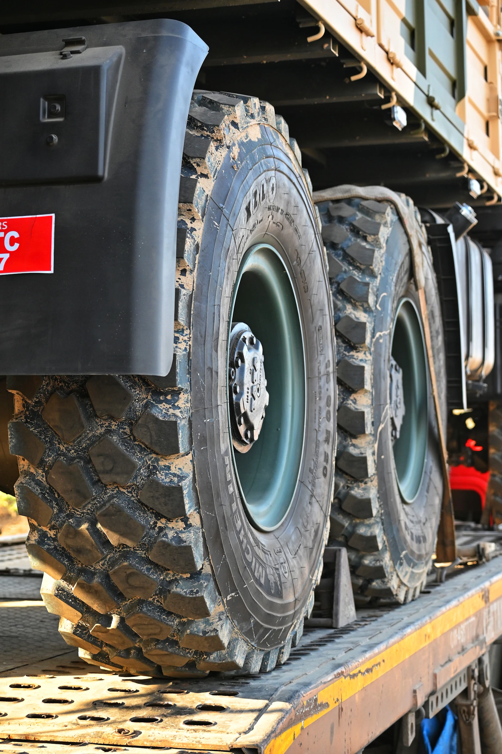 Flatbed trailer loaded with heavy equipment for transport