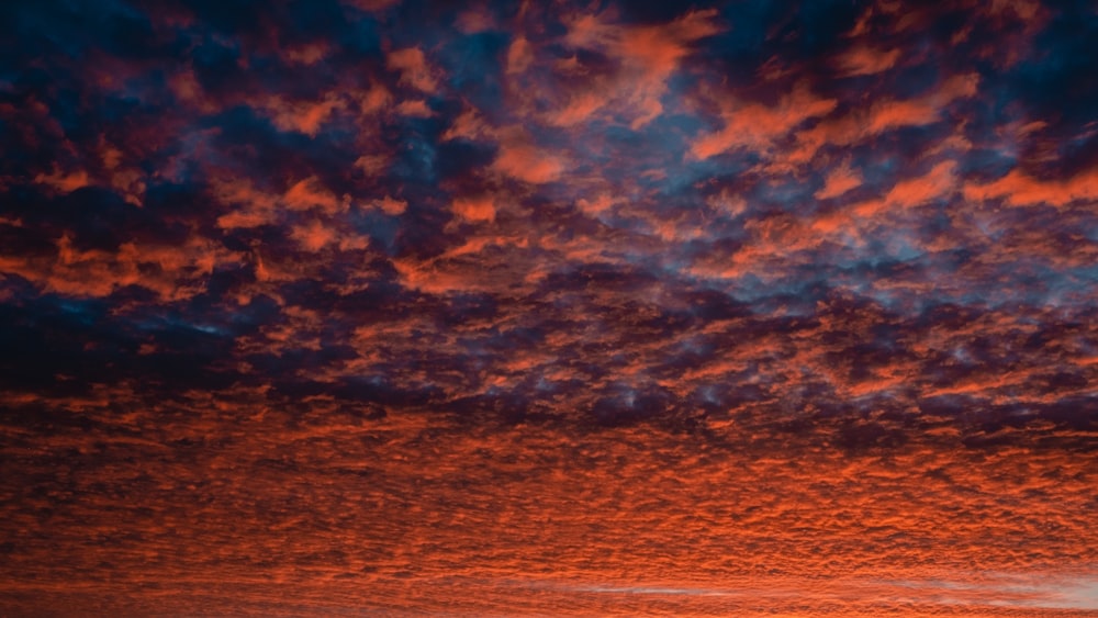 a red sky with a few clouds in it