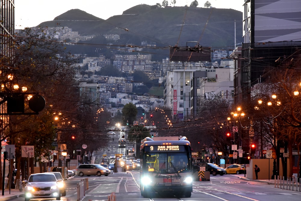 a bus driving down a city street at night