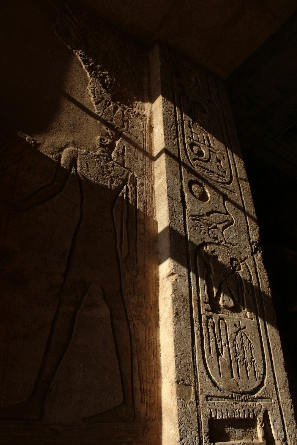 a stone carving of an egyptian god on a wall