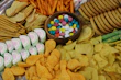 Assortment of colorful gourmet snacks arranged invitingly on a wooden platter.
