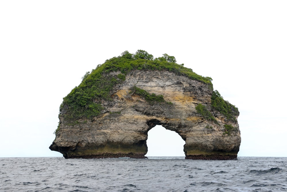 a large rock formation in the middle of the ocean