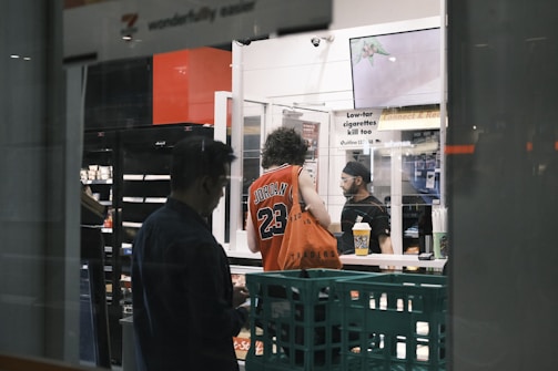 a couple of people standing in front of a machine