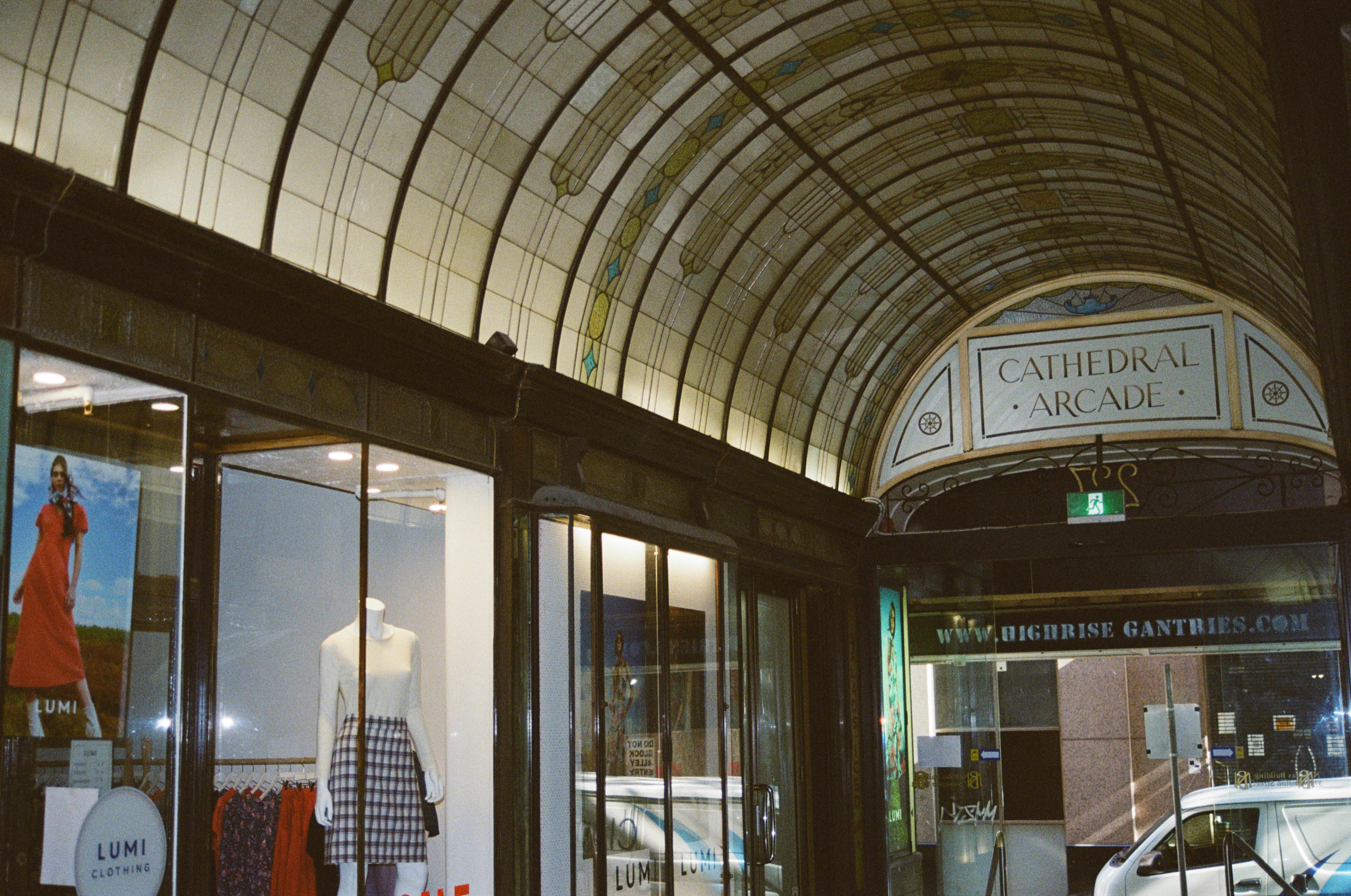 a car is parked in front of a clothing store
