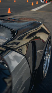 Close-up of a sleek composite buggy shell with metallic flake finish reflecting sunlight
