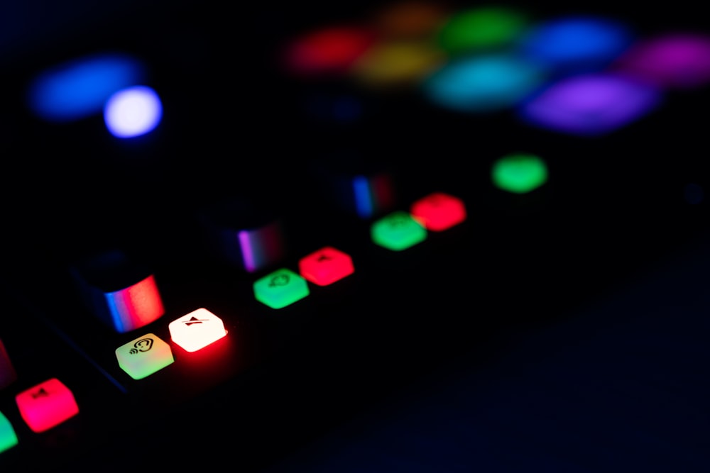 a close up of a keyboard with colored lights on it