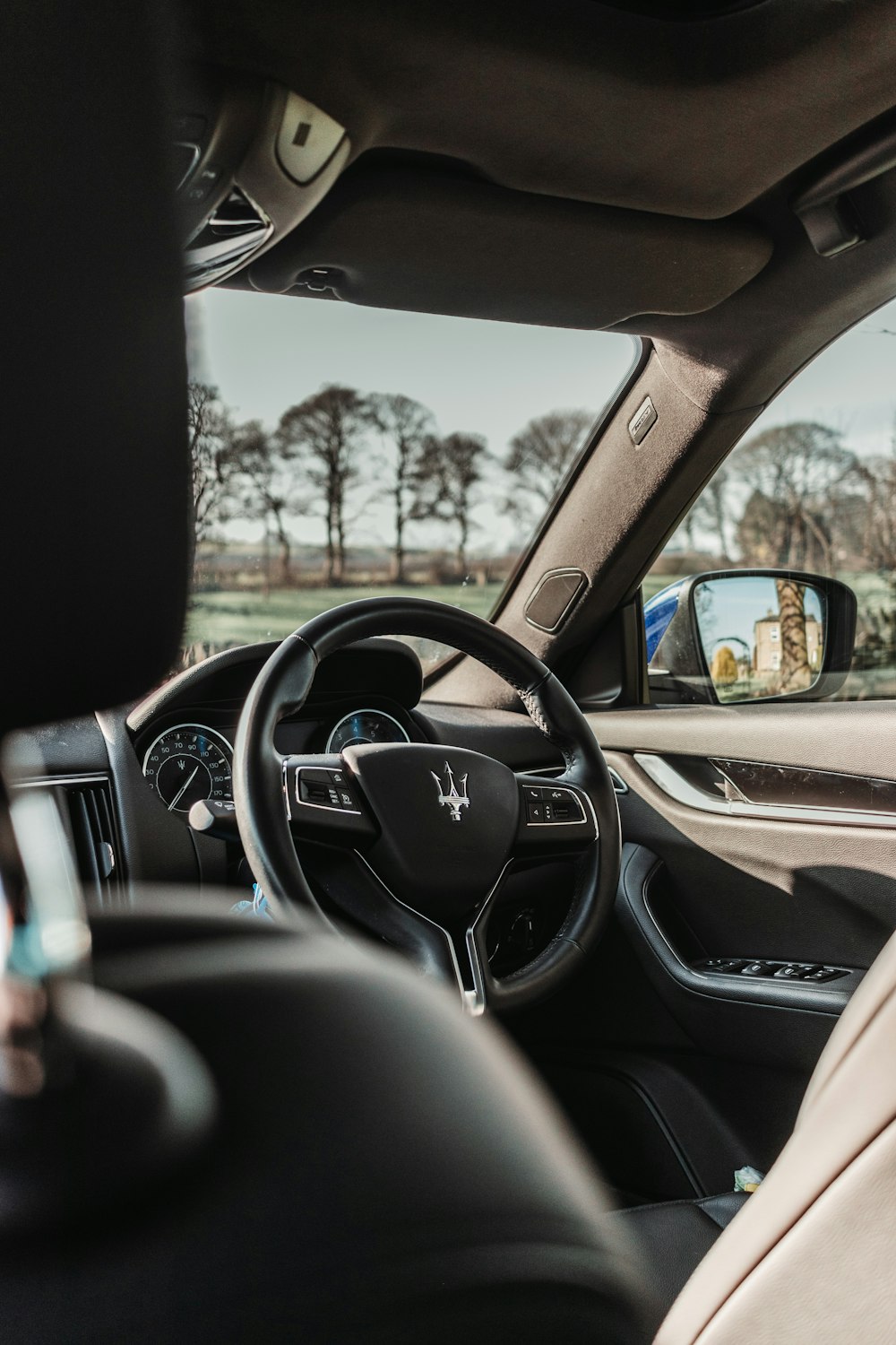 the interior of a car with a view of the driver's side mirror