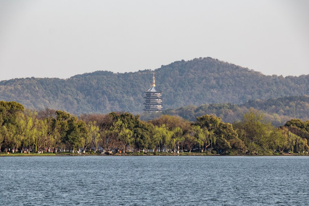a large body of water with a tall tower in the background