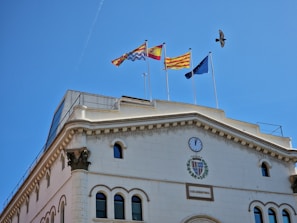 a building with flags flying in the wind