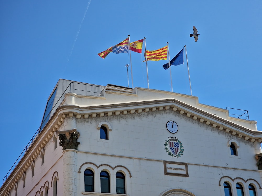 a building with flags flying in the wind