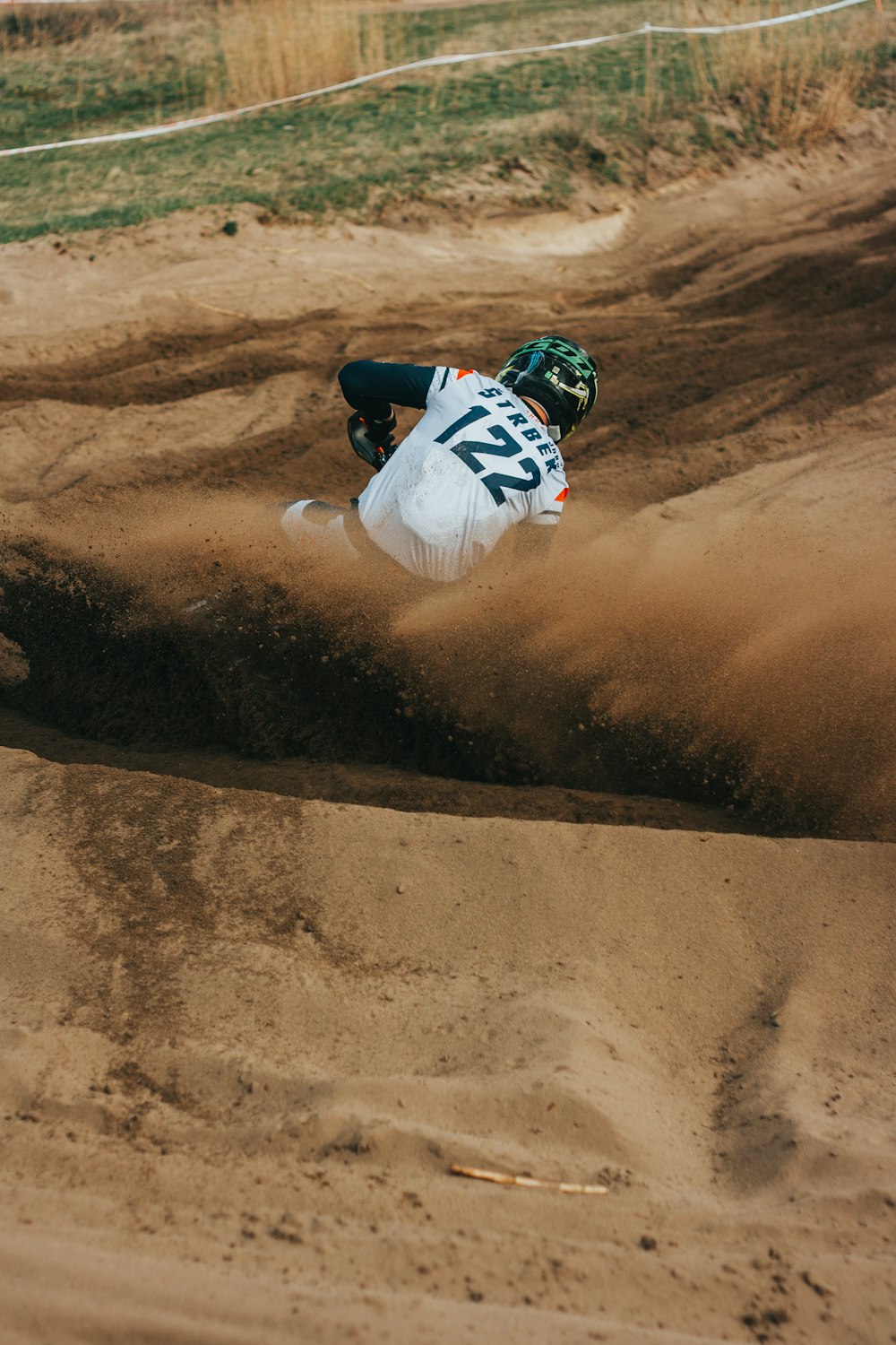a man riding a dirt bike on top of a dirt field