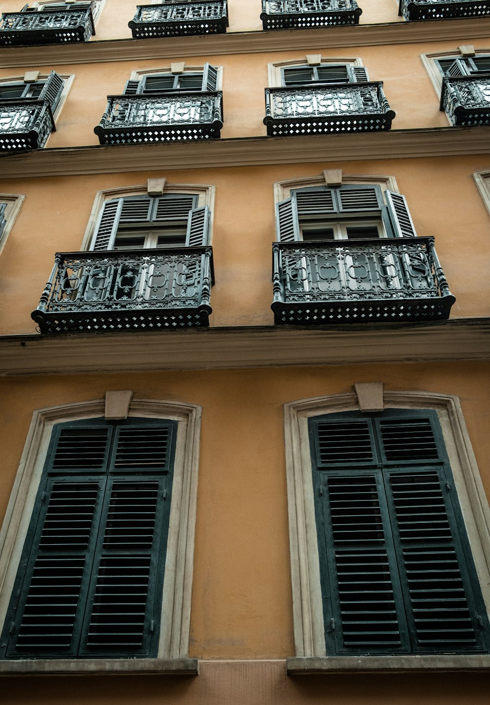 a tall building with lots of windows and shutters