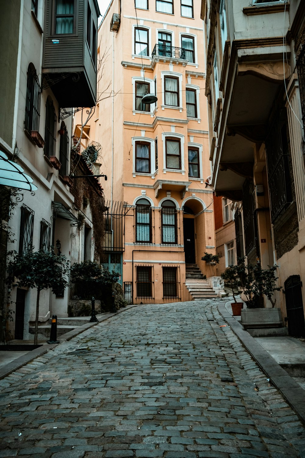 a cobblestone street with a building in the background