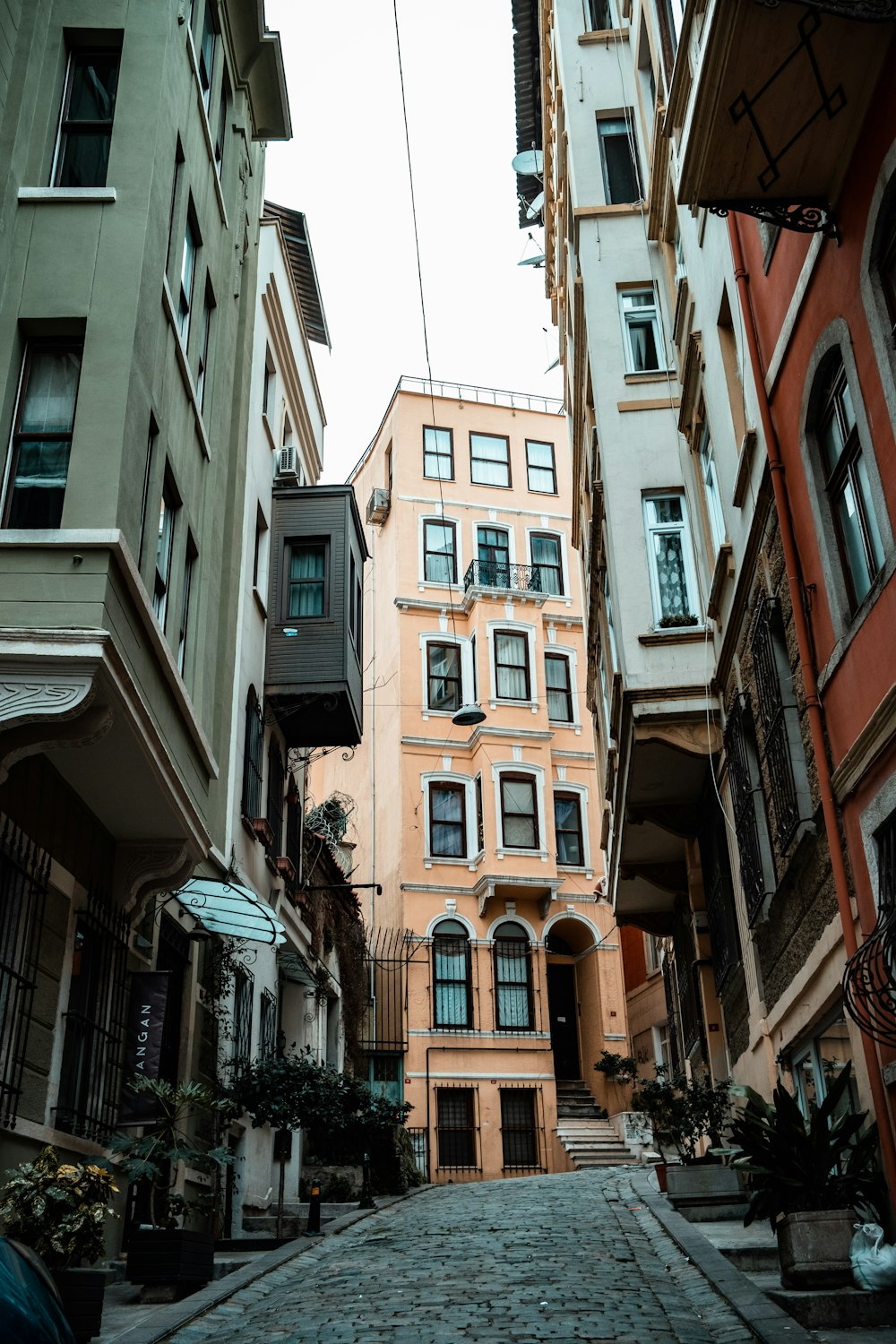 a cobblestone street lined with tall buildings