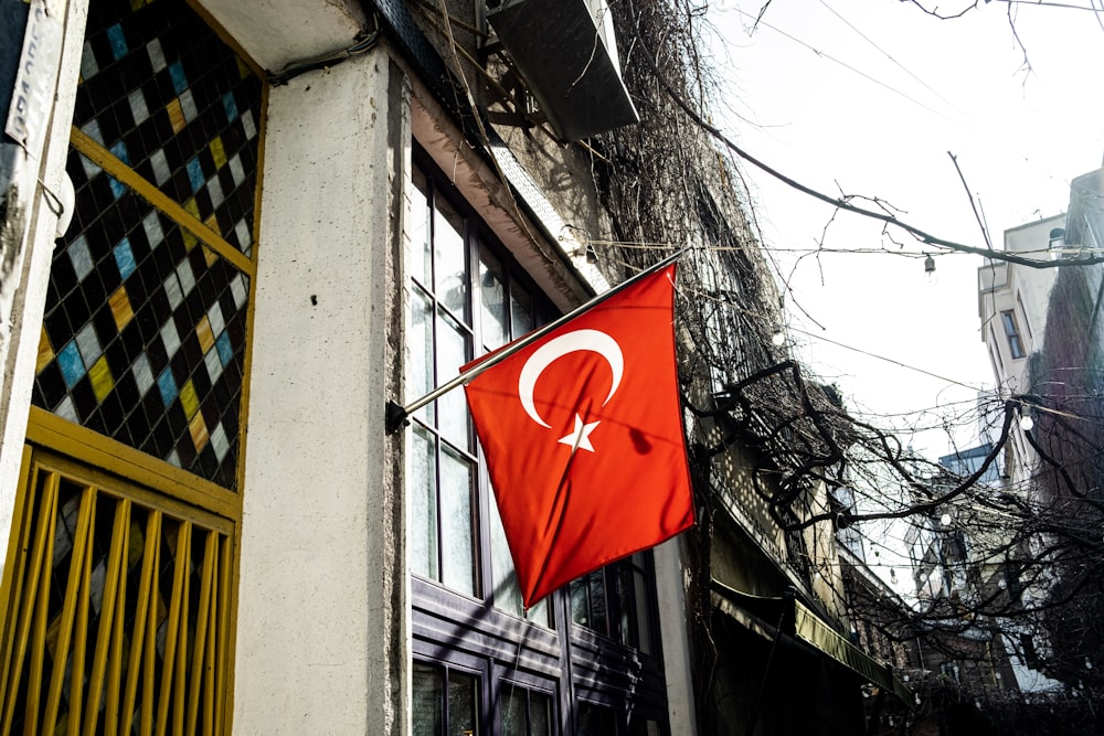 a turkish flag is hanging on a building