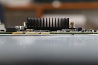 Detailed shot of a DC/DC converter with heatsink fins and surrounding power management circuitry.