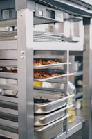a commercial oven with several trays of food in it